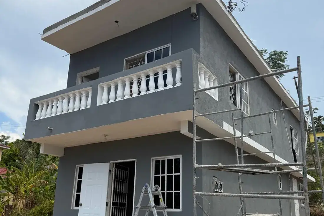 The same house rendered and repainted in grey with the balustrade picked out in white