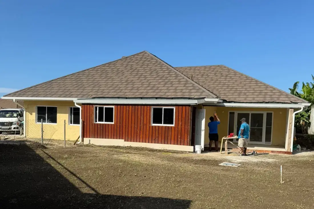 The same house with the roof decked, shingled and the eaves closed in