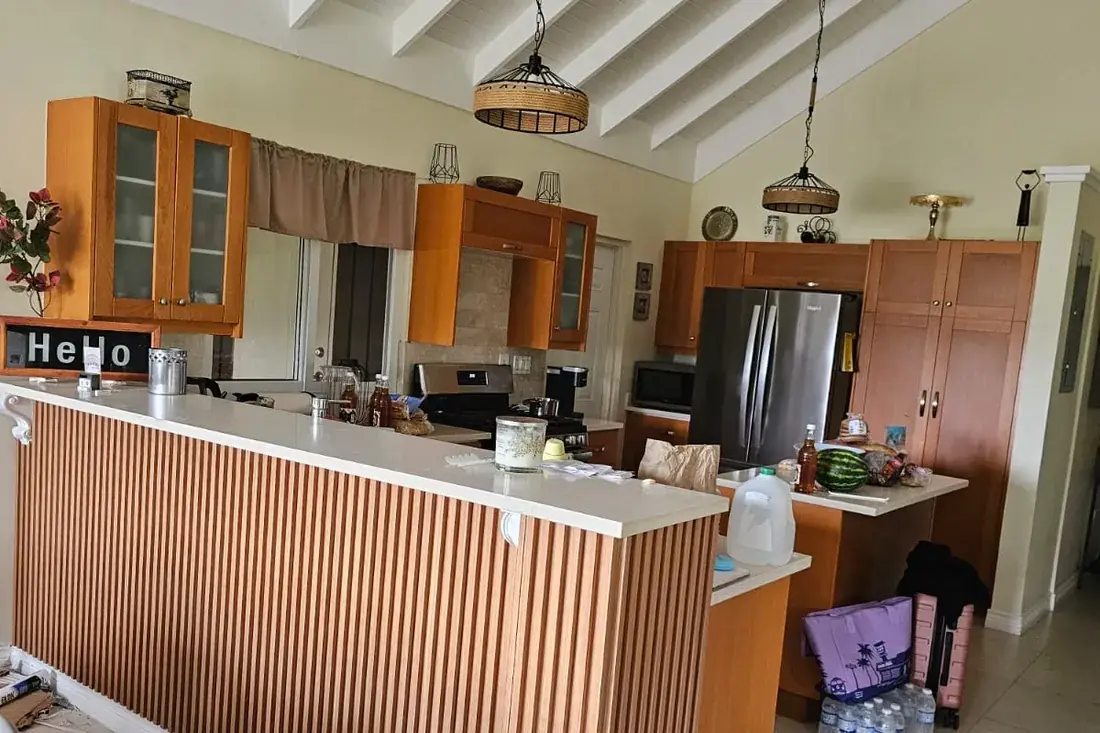 The same counter front clad in vertical timber slats, returned around the corner