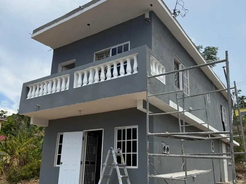 The same house rendered and repainted in grey with the balustrade picked out in white