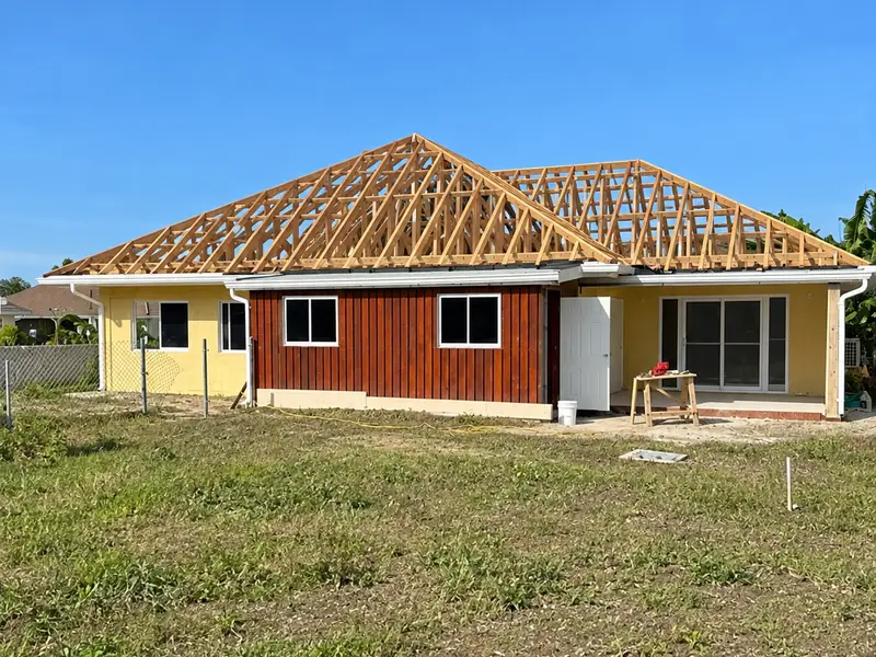 A house with the roof trusses set out and braced, open to the sky