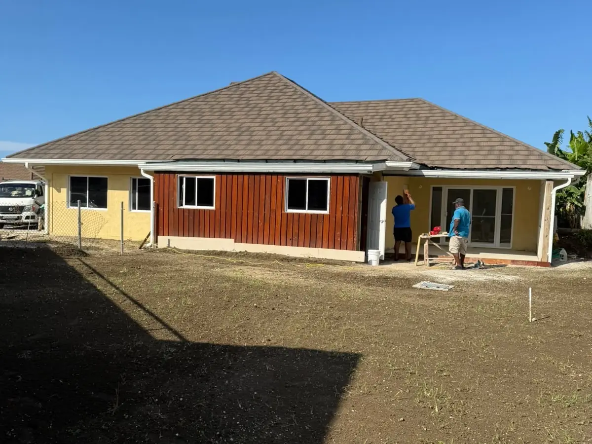 A completed Max Team house under a clear sky, roof and render finished